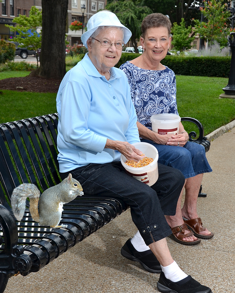 Mary Alice Oliver (L) and Kay Dillon (R) feeding the squirrels in Fountain Square Park.